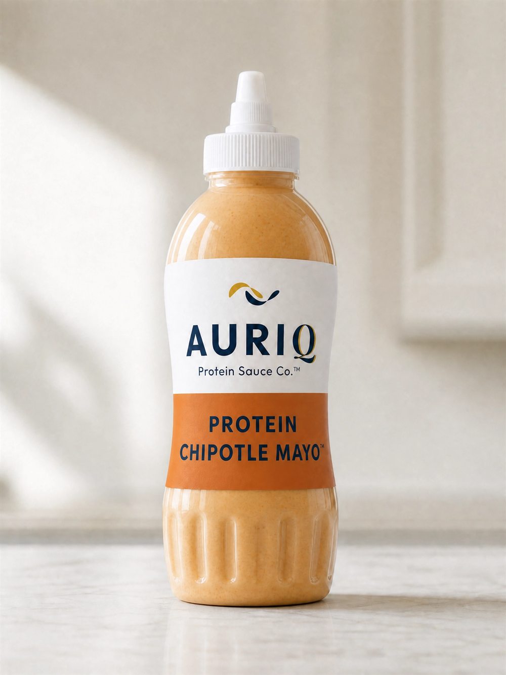 AURIQ Protein Chipotle Mayo squeeze bottle on a kitchen counter
