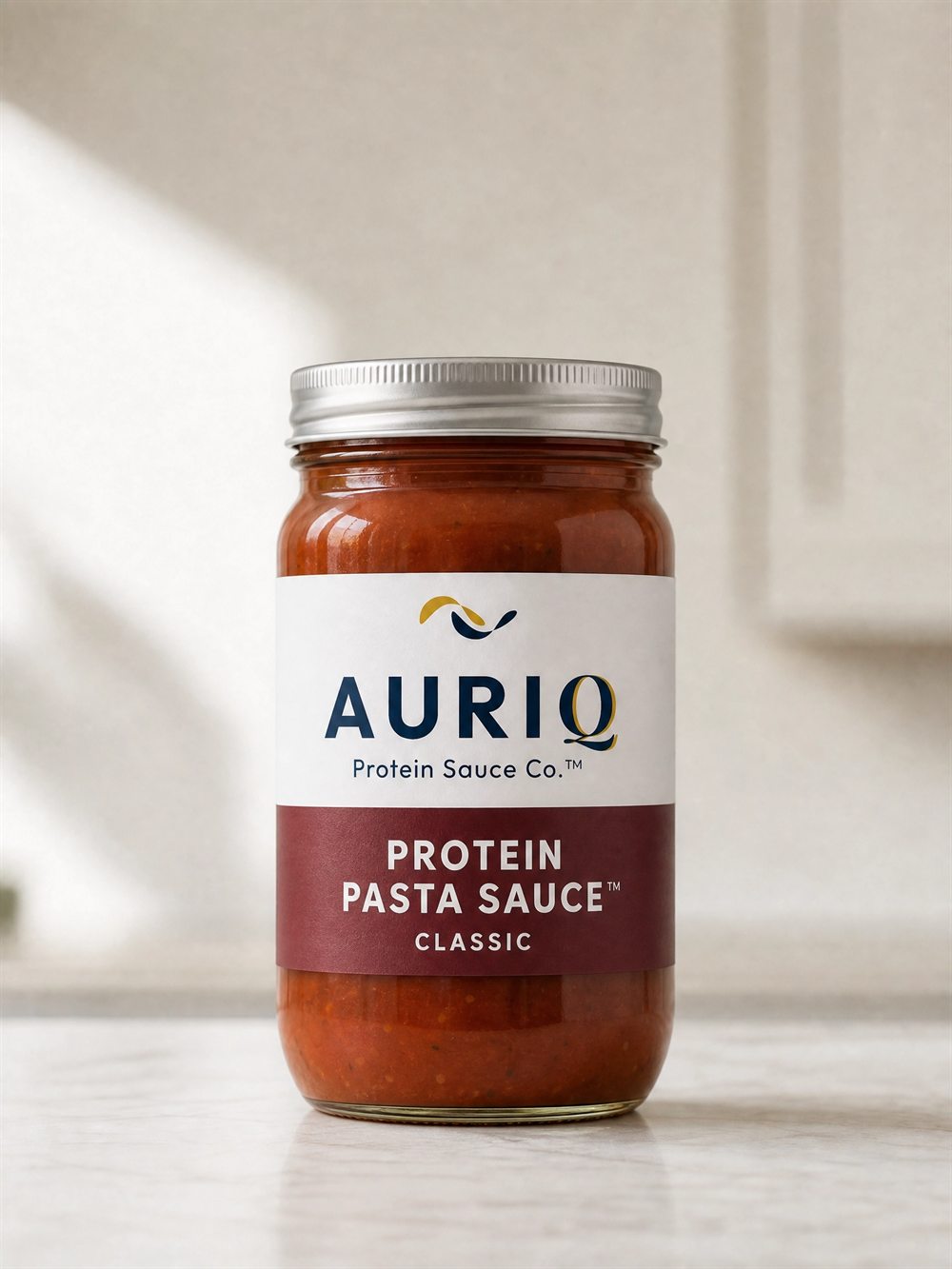 AURIQ Protein Pasta Sauce glass jar on a kitchen counter