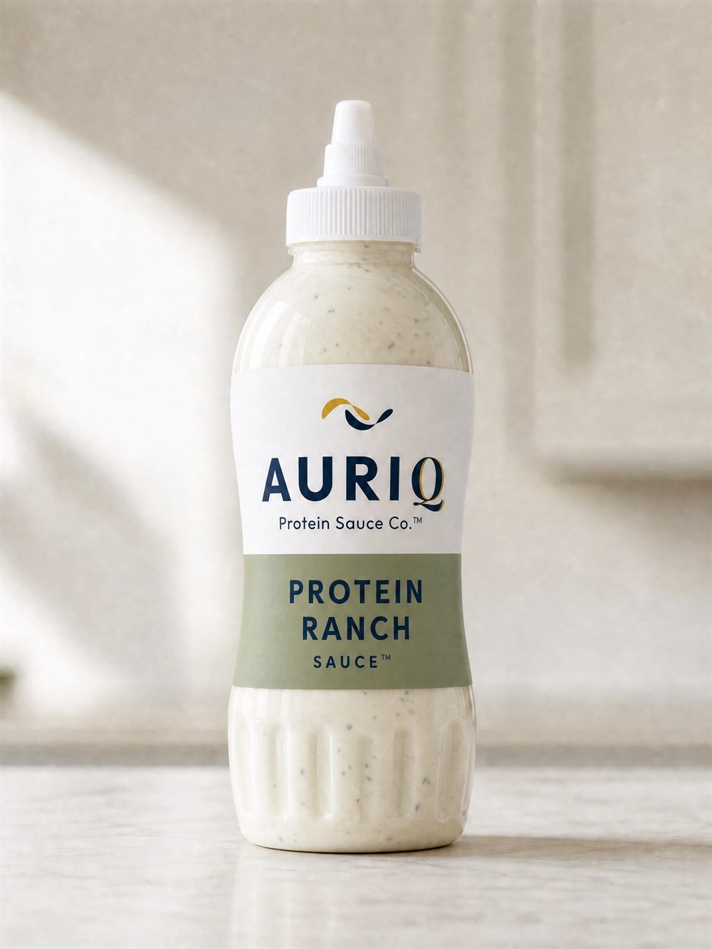 AURIQ Protein Ranch Sauce squeeze bottle on a kitchen counter